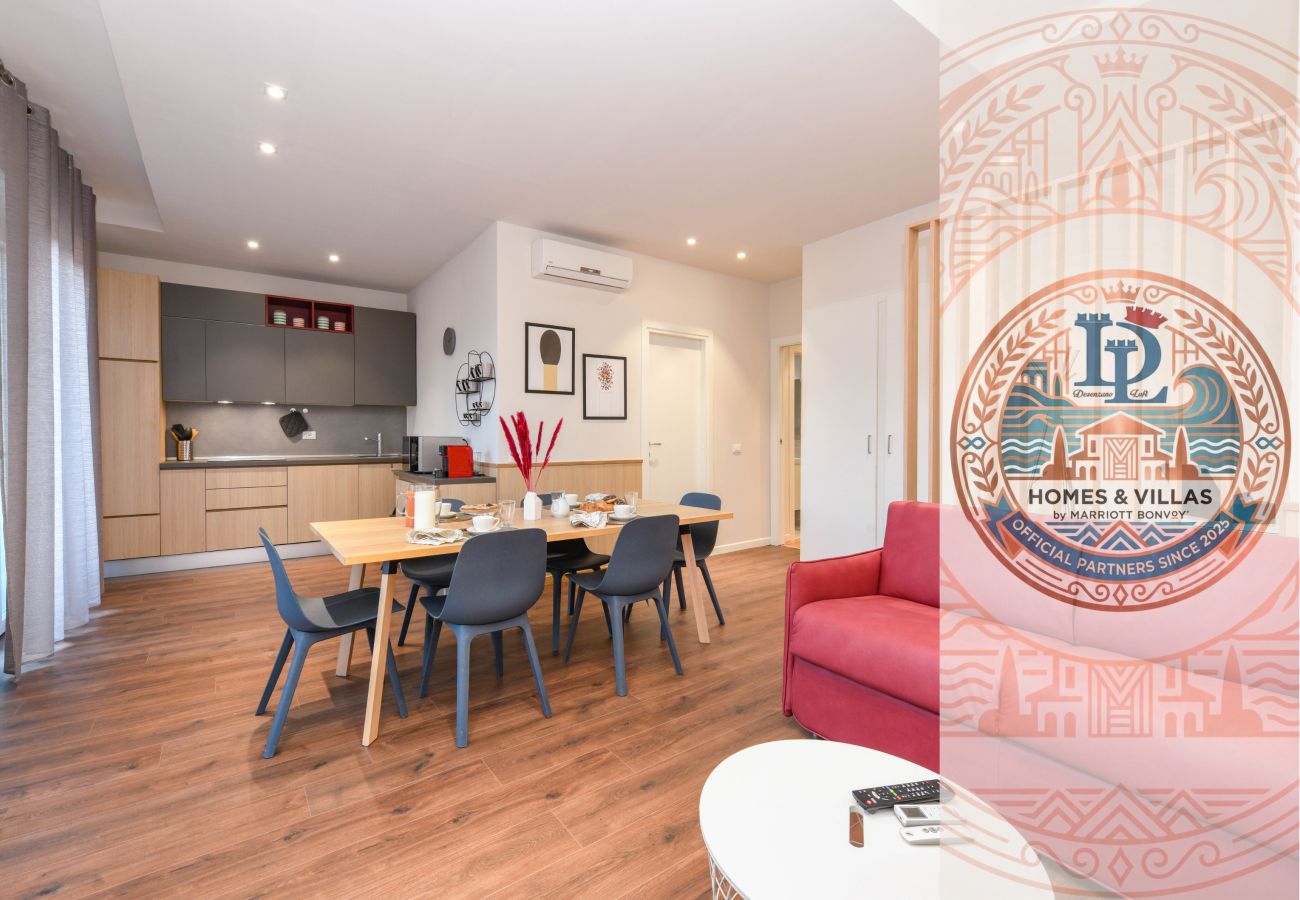 Ampio soggiorno open space con divano, area pranzo e cucina a Desenzano