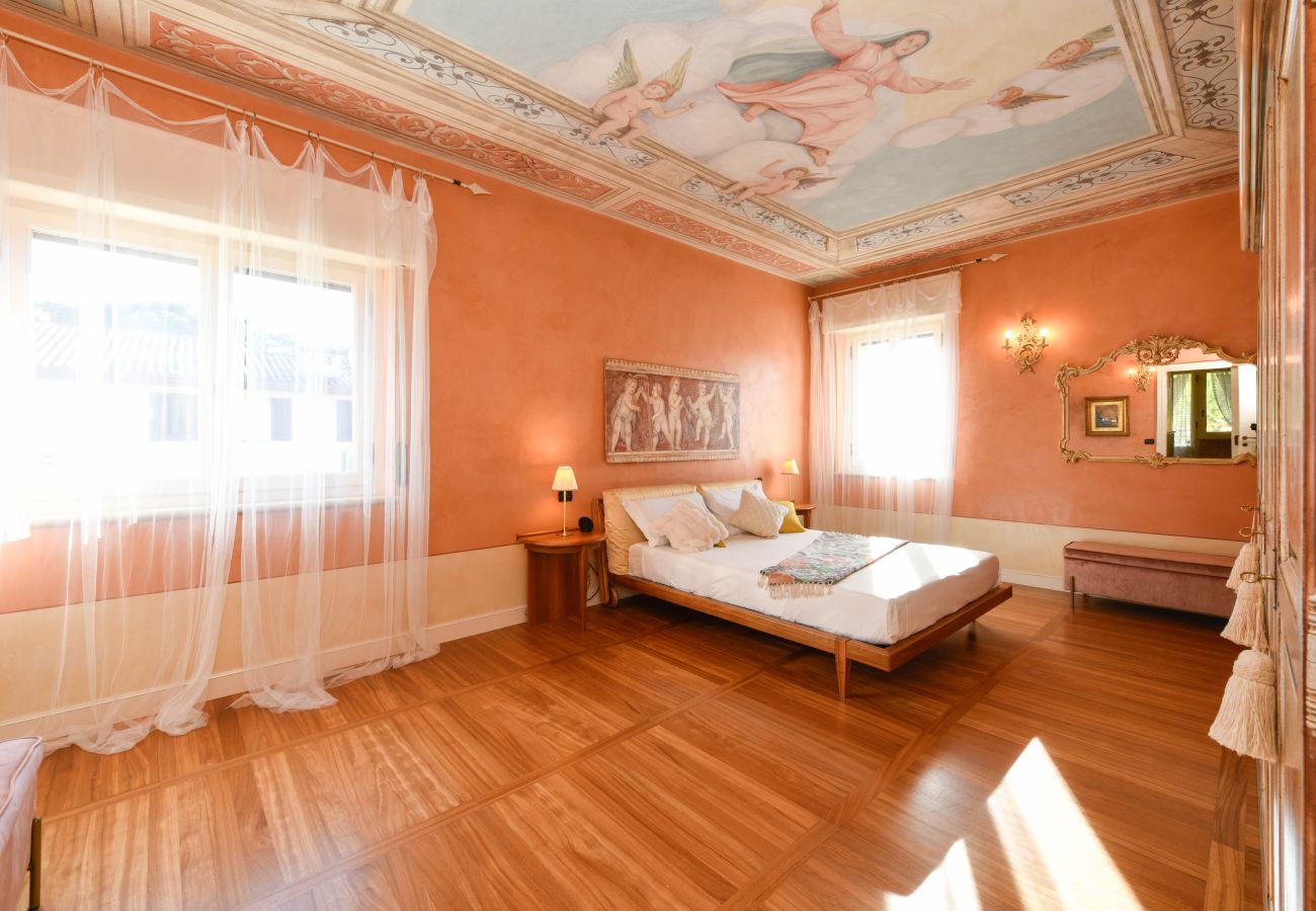 Camera matrimoniale di Villa Bugatti con soffitto affrescato e arredi eleganti