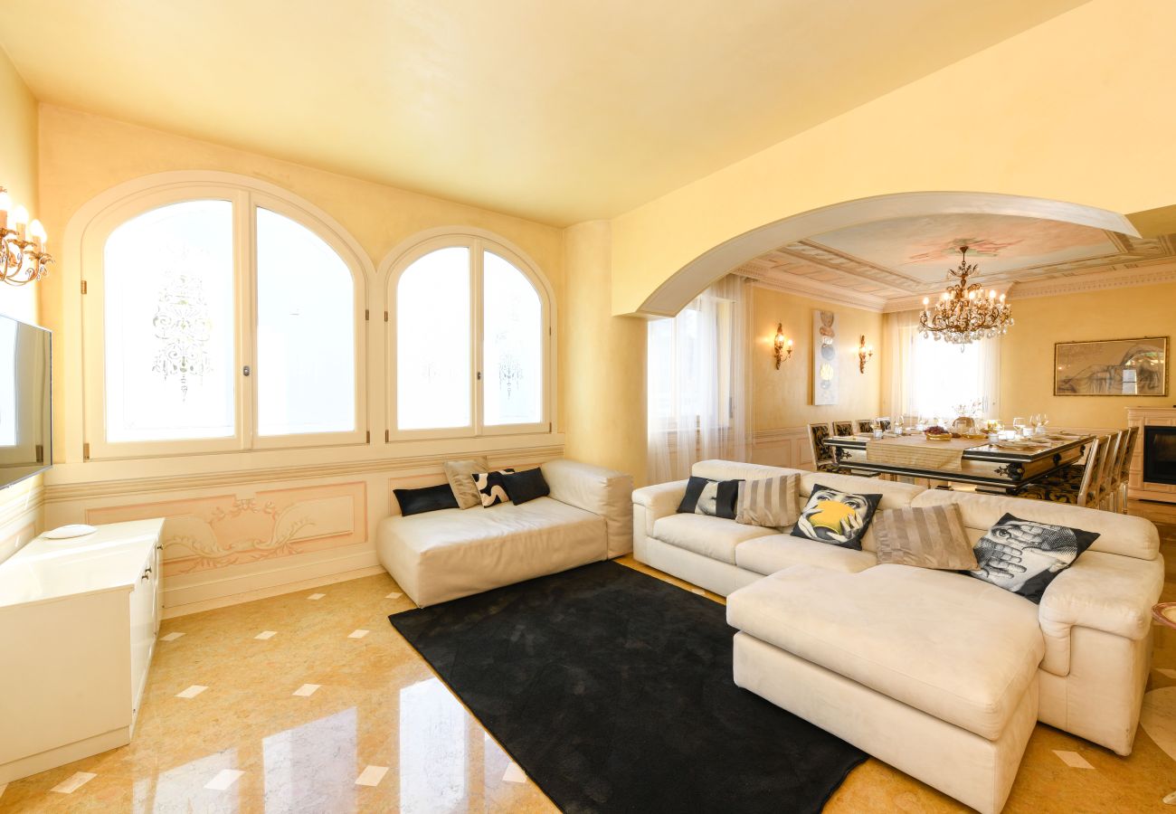 Opulent living area with marble floors and chandeliers