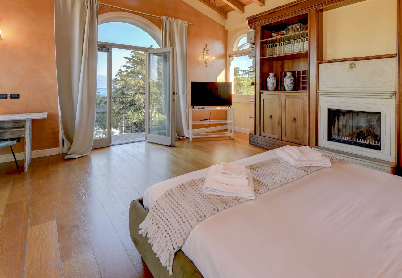 Luxury attic bedroom with wooden beams in private villa