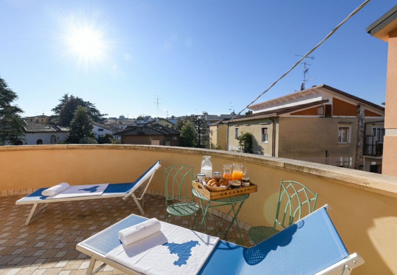Private terrace furnished with sun loungers at Villa Bugatti